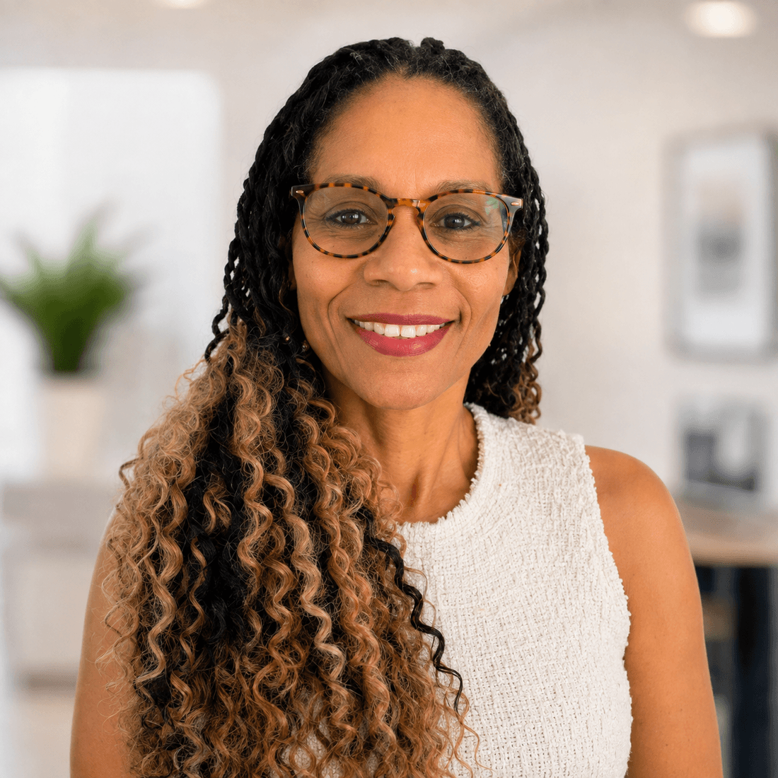 Alexandria, founder and lead trainer at Athena Learning Hub, smiling in a bright workspace.